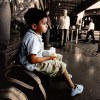 Boy waitin on a bus in Mendoza, Argentina