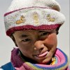 Child in Tibet with Buddhist deer hat