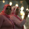 Muslim women taking photograps in Istanbuls Blue Mosque