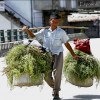 Nepali man carrying baskets in Kathmandu