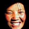 Smiling Tibetan girl coming out of the dark