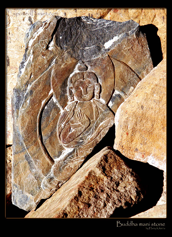 Buddha image in mani stones pile