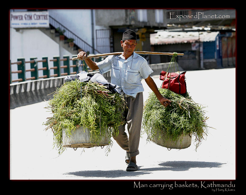 Nepali man carrying baskets in Kathmandu