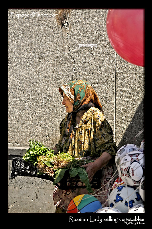 Russian lady selling vegetables on the market