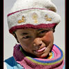 Photo of Child in Tibet with Buddhist deer hat on ExposedPlanet.com