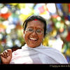 Photo of Happy Woman in Kathmandu with prayer flags on ExposedPlanet.com