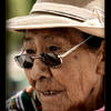 Photo of Old woman in Puno, Peru selling sweets on ExposedPlanet.com