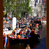 Photo of Orange boats in the Amsterdam canals at Queensday on ExposedPlanet.com