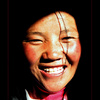 Smiling Tibetan girl coming out of the dark