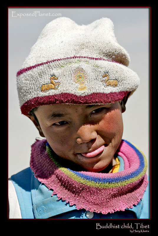 Child in Tibet with Buddhist deer hat