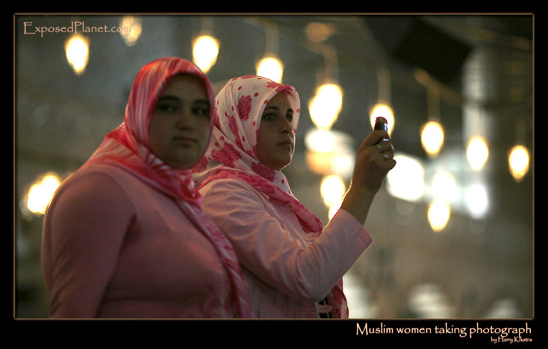 Muslim women taking photograps in Istanbuls Blue Mosque