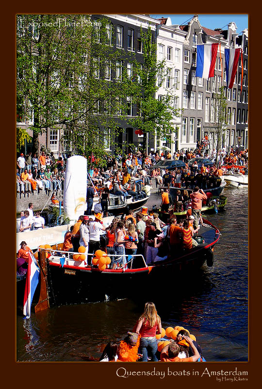 Orange boats in the Amsterdam canals at Queensday