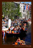 Orange boats in the Amsterdam canals at Queensday